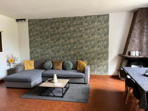 a living room with a couch and a table at Charmante maison avec jardin in Villeneuve-sur-Lot