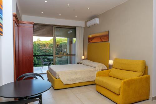 a bedroom with a bed and a chair and a table at Domus Aurelia in Rome