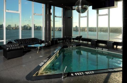 a swimming pool in a building with a view of the city at The Standard, High Line New York in New York