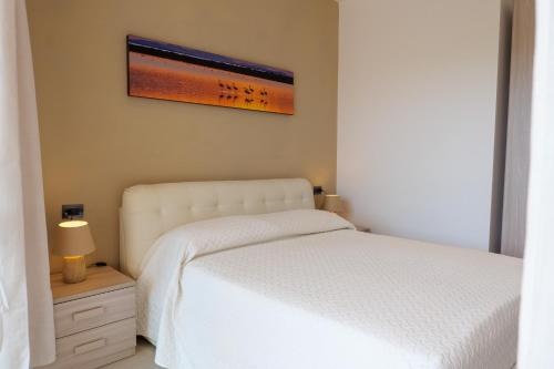 a bedroom with a white bed and a picture on the wall at Domus Aurelia in Rome