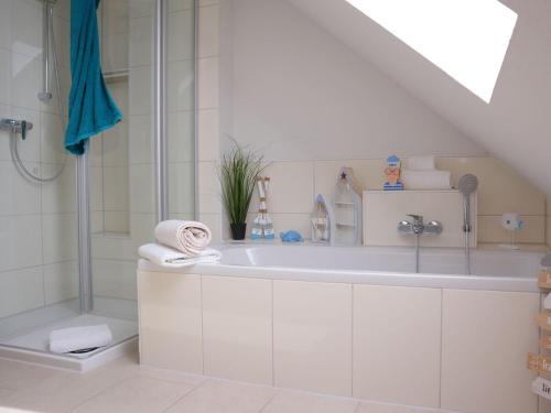 a white bathroom with a sink and a shower at Ferienhaus Lee in Dorum Neufeld