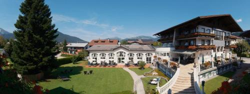 a large house with a large lawn in front of it at Genuss - und Vitalhotel Moisl in Abtenau
