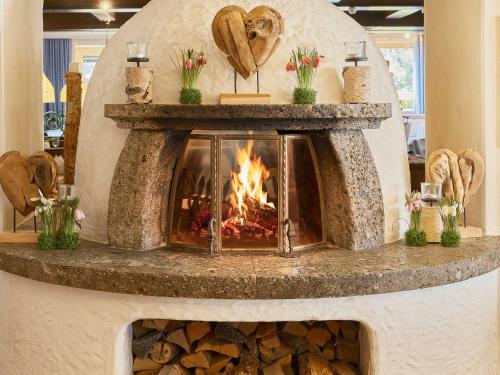 a fireplace in a store with a fire place at Genuss - und Vitalhotel Moisl in Abtenau