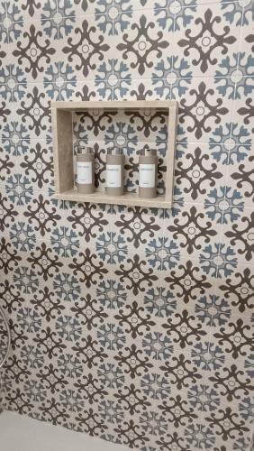 a bathroom with blue and white tiles on a wall at Silvia's at 141 in Genzano di Roma