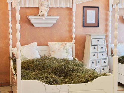 a bedroom with a bed with a pile of hay at Genuss - und Vitalhotel Moisl in Abtenau