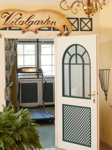 a door to a kitchen with a sign above it at Genuss - und Vitalhotel Moisl in Abtenau
