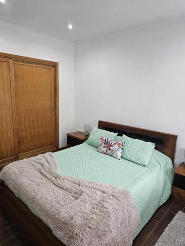 a bedroom with a bed with a blanket on it at Casa da estrela sirius in Cabeço Chão