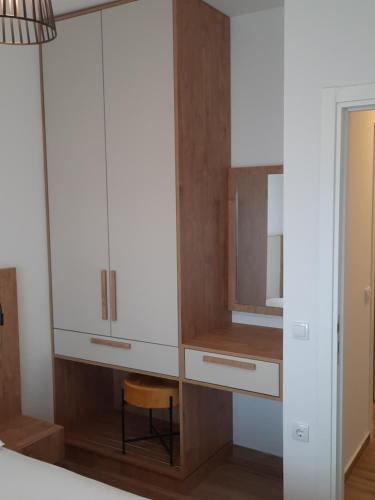 a bedroom with a dresser and a mirror at Eagles Locus Apartments in Ulcinj