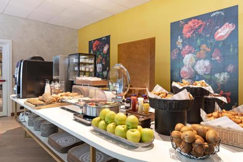 a buffet of food on a counter in a restaurant at B&B Hotel Como City Center in Como