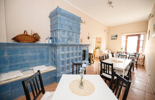 a dining room with tables and chairs and a blue wall at Hotel Modrásek in Kašperské Hory