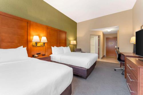 a hotel room with two beds and a television at Comfort Inn & Suites LaVale - Cumberland in La Vale