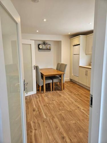 a kitchen and dining room with a table and chairs at The Old Bar Newly Renovated in Killare