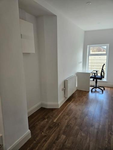 an empty room with a desk and a chair at The Old Bar Newly Renovated in Killare