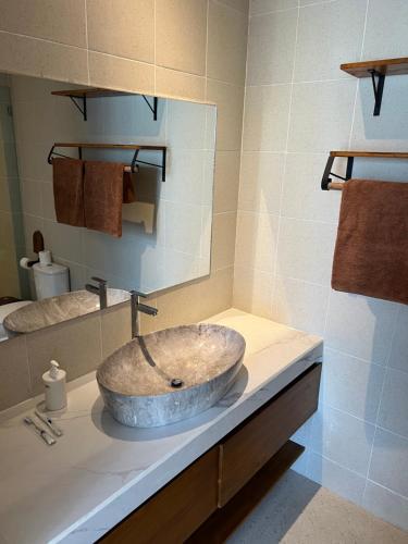 a bathroom with a stone sink on a counter at Sari Hills Bali in Nusa Dua
