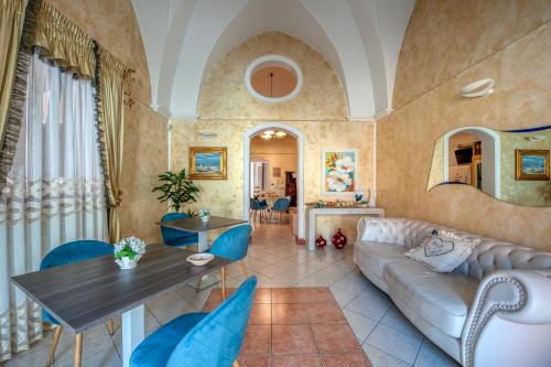 a living room with a couch and a table at Il Geco in Salice Salentino