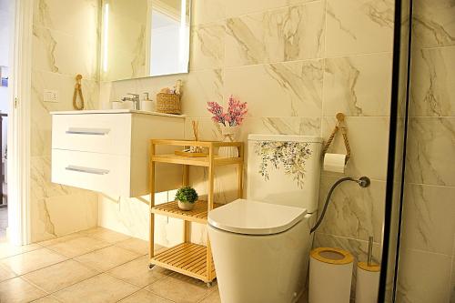 ein Badezimmer mit Toilette und Waschbecken in der Unterkunft Apartamento,BBQ, cerca del mar in Charco del Pino