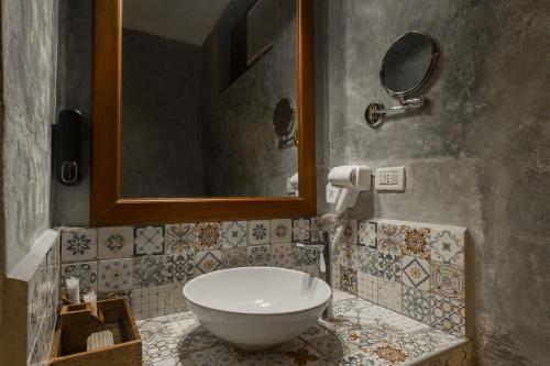 a bathroom with a sink and a mirror at Kiwengwa Beach Resort in Kiwengwa