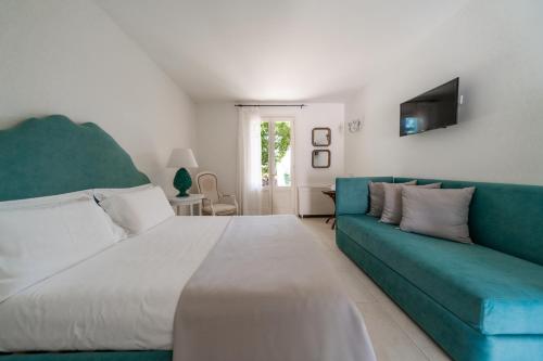 a bedroom with a large bed and a couch at Tenuta Centoporte in Otranto
