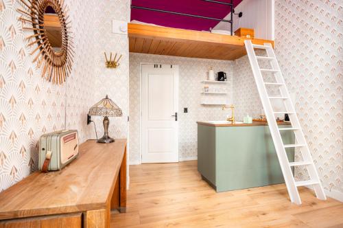 a room with a bunk bed with a desk and a ladder at The Disco Duck - 15 guests - city centre Zwolle in Zwolle