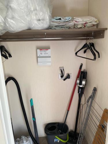 a room with a shelf with some mop at 59 Cliff Field in Hopton on Sea