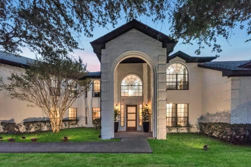 a large house with a front door at Lakefront Luxe 6BR 4,5BA Holiday Home with Pool & Hot Tub in Rowlett