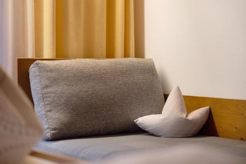 a white pillow sitting on top of a bed at Bed and Breakfast Ederhof in San Giacomo