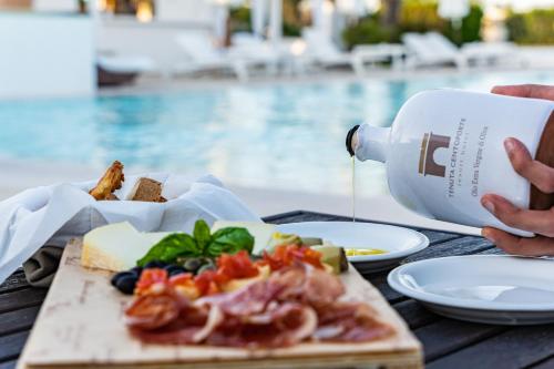 a table with food and a bottle of milk at Tenuta Centoporte in Otranto