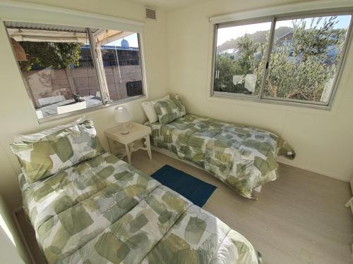 a small room with a bed and a couch at Stay on Main in Lappiesbaai
