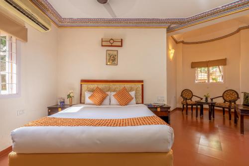 a bedroom with a large bed in a room at Vijayshree Resort, Hampi in Hampi