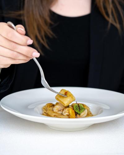 a woman eating a plate of food with a fork at Tenuta Centoporte in Otranto