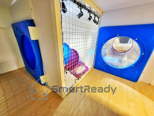 a play room with a dog in a cage at Sunway GRID by SR Home in Kampong Pendas