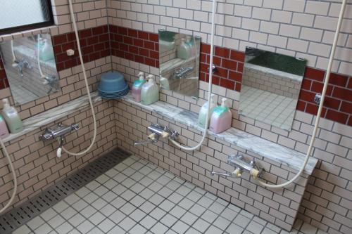 a public bathroom with two sinks with soap bottles at Sugakuso in Yamanakako
