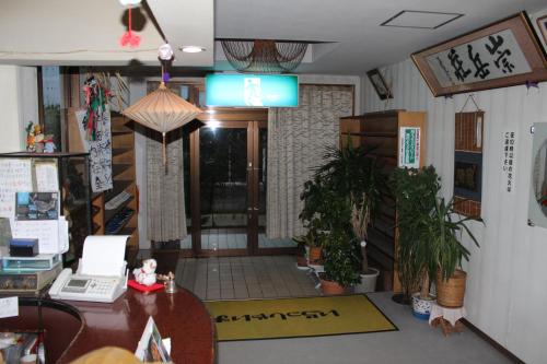 an office with a desk and a table with a laptop at Sugakuso in Yamanakako