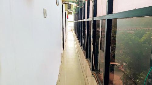 an empty hallway of a building with large windows at Hotel Maharaja Inn By The Premium Villa in New Delhi