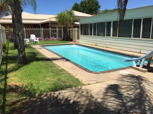 a swimming pool in front of a house at Balranald Motor Inn in Balranald