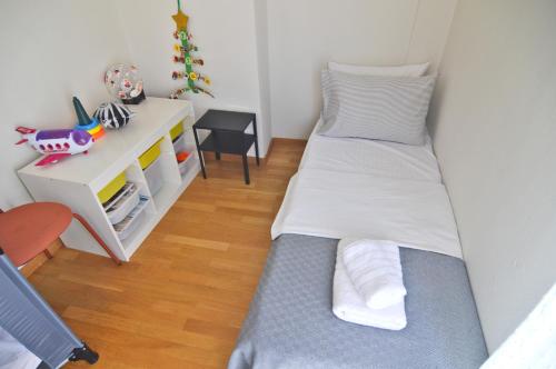a bedroom with two beds and a desk at Leonidas' privileged home in Kastoria