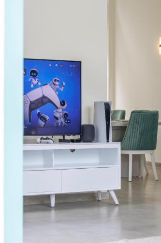 a tv sitting on top of a white dresser at Nomad Nest in Hikkaduwa