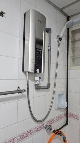 a shower in a bathroom with a phone on the wall at Near USM 6 pax, 2 Bedroom w Aircond, 2 toilet, 5G WIFI in Si Dua Besar