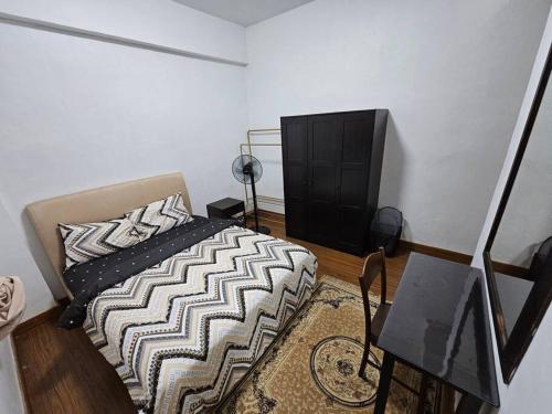 a bedroom with a bed and a dresser at Near USM 6 pax, 2 Bedroom w Aircond, 2 toilet, 5G WIFI in Si Dua Besar