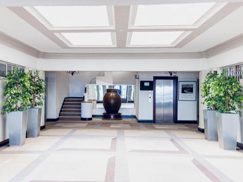 a lobby with a vaulted ceiling and plants at Mouille Point Villa Capri in Cape Town