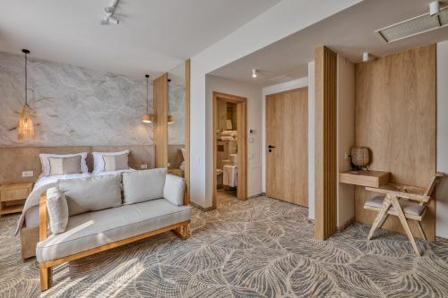 a bedroom with a bed and a couch at Hotel Serenity Timisoara in Timişoara