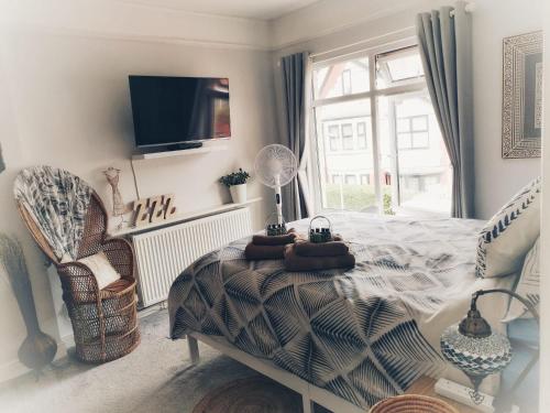a bedroom with a bed and a table and a window at Aqua View, New Brighton Beach- 2 Bedroom with BALCONY & VIEW in New Brighton