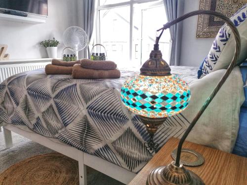 a table with a lamp on top of a couch at Aqua View, New Brighton Beach- 2 Bedroom with BALCONY & VIEW in New Brighton