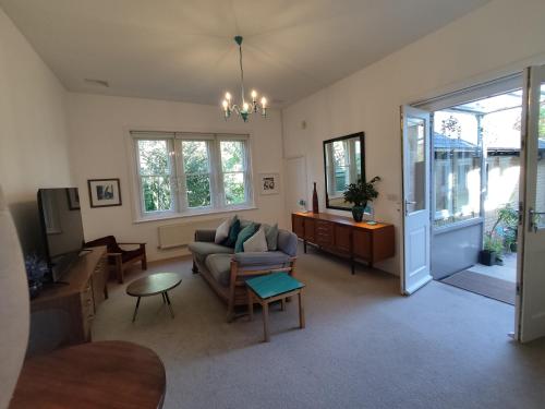 a living room with a couch and a table at Spacious 2 bedroom apartment in Taunton