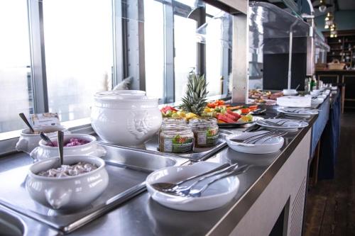 a buffet line with plates and bowls of food at Hotel Dömitzer Hafen in Dömitz