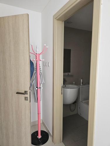 a bathroom with a pink statue in a room at Texico Muscat Down TownHostel in Ghubrah