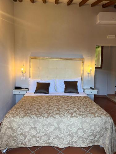 a bedroom with a large bed with two pillows at Leon Bianco in San Gimignano