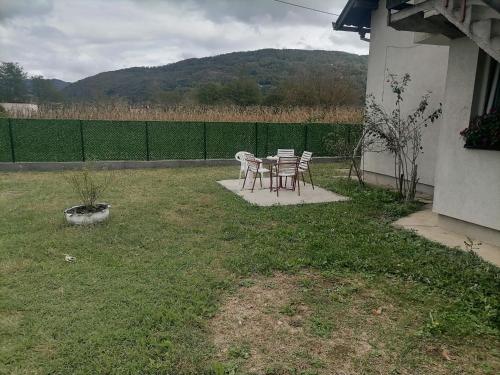 a patio with chairs and a table in a yard at Kuća za odmor IN Bajina Basta in Bajina Bašta