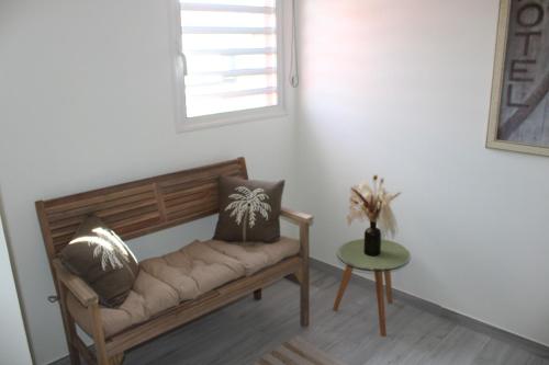 a couch in a room with a table and a window at COCON DES ANTILLES in Le Vauclin