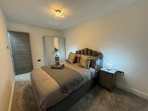 a bedroom with a large bed and a night stand at Stunning home Excellent location in Manchester